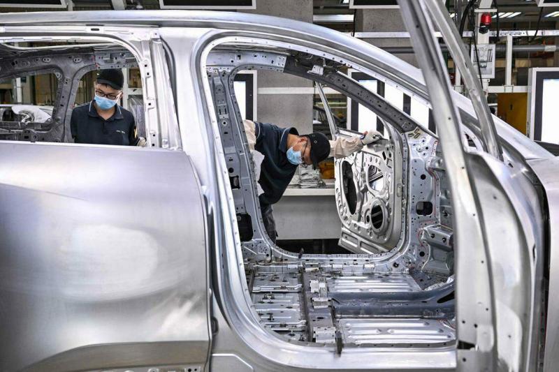 蔚来工作人员在把电动车送去喷漆前做检查。(法新社)