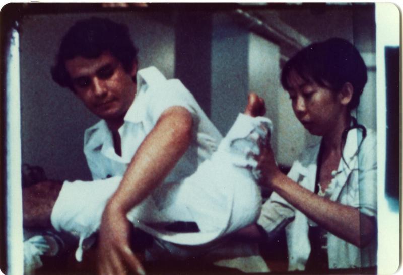 在护士阿莫的协助下,洪瑞钗(右)为病人进行包扎。图摄于1982年加沙医院。(受访者提供)