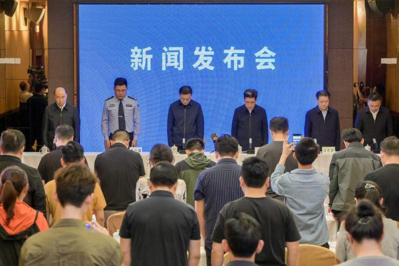 中共梅州市委书记马正勇(左三)、梅州市长王晖(右三)星期四(5月2日)在新闻发布会上率领与会官员全体起立为高速公路塌陷事故遇难人员默哀1分钟。(中新社)