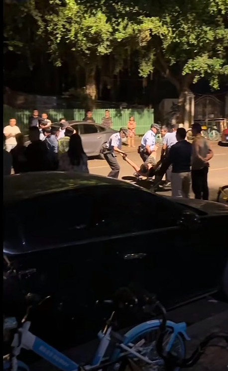 成都警方到场后,强行将张男带离现场。(互联网)