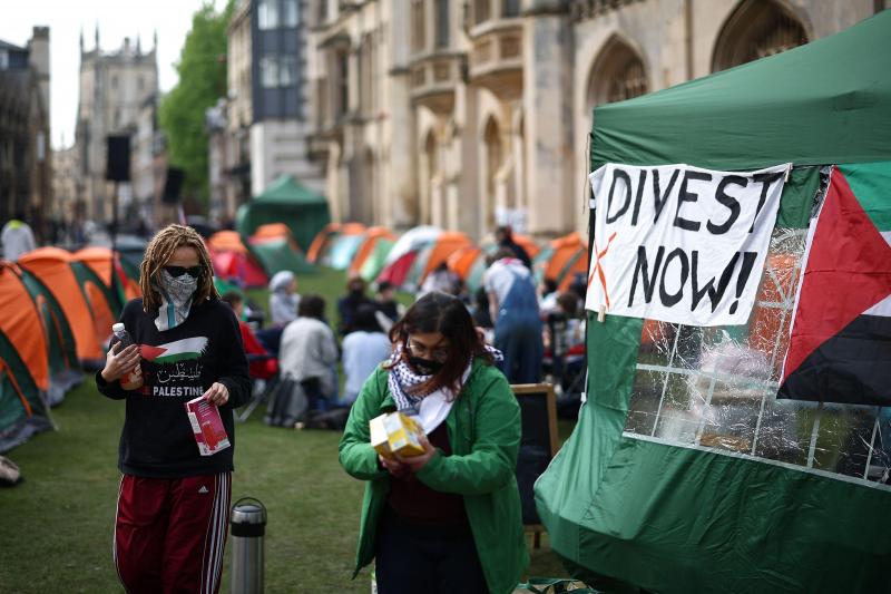 5月7日,英国剑桥大学的亲巴勒斯坦学生在国王学院搭帐篷,他们挂在帐篷上的标语要求校方从以色列撤资。(法新社)